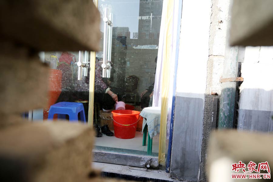 墻內(nèi)一家店面正常營(yíng)業(yè)。