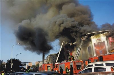 11日，蘋果園喜隆多商場，火災現(xiàn)場濃煙滾滾。新華社發(fā)