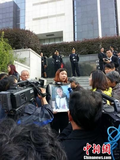 法院外，死者祁某的家人正在接受媒體采訪。 田雯 攝