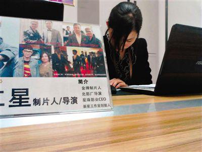 4月17日，西土城錦秋家園面試點(diǎn)，工作人員在為招聘者填寫材料，桌上擺著公司負(fù)責(zé)人李仁星與甄子丹、李連杰等明星合影。