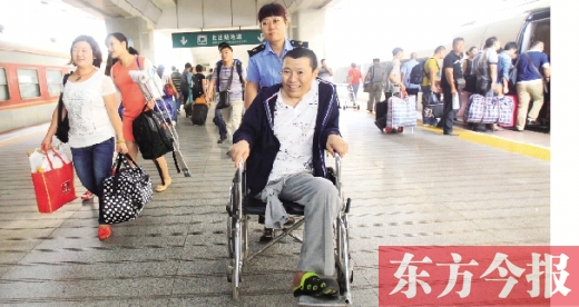 李剛手術(shù)后歸來，在車站工作人員幫助下走出鄭州火車站站臺(tái)  東方今報(bào)首席記者 張曉冬 攝