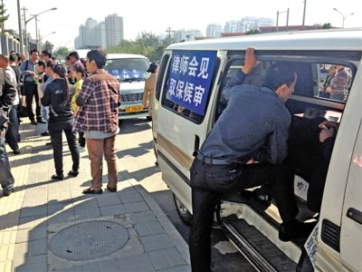 昨日，朝陽(yáng)區(qū)看守所門前有人排隊(duì)。大門外還停有多輛寫有“律師會(huì)見(jiàn)”字樣的車。
