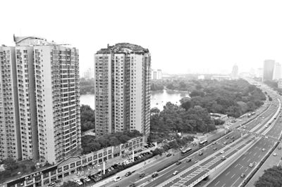 昨日，人濟(jì)山莊小區(qū)，與其他樓相比，B棟樓頂層天臺(tái)上違規(guī)建造了一棟兩層小樓，假山大樹(shù)俱全。新京報(bào)記者