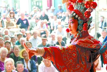 圖為8月15日戲曲演員在“流動舞臺車”上表演傳統(tǒng)地方戲《穆桂英下山》。