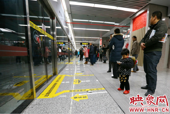 小朋友在等候區(qū)內(nèi)等待地鐵。