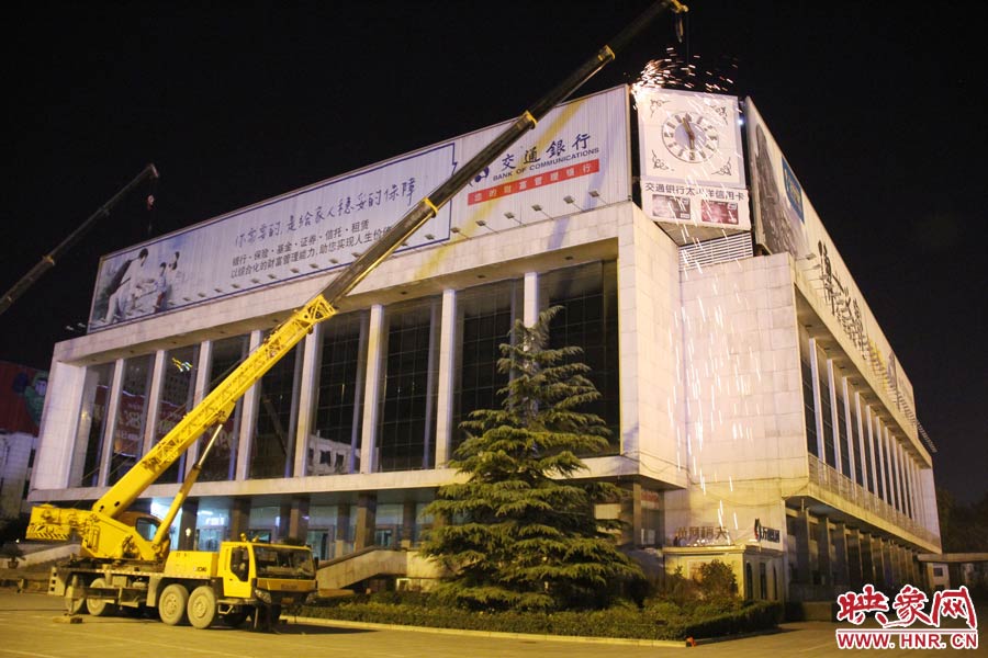 21點50分，切割機(jī)開始對中間最小的一塊牌進(jìn)行切割。頂著“呼呼”的寒風(fēng)，巨大廣告牌上火花四濺。